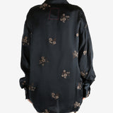 Black top worn by a person, showing the top's fit