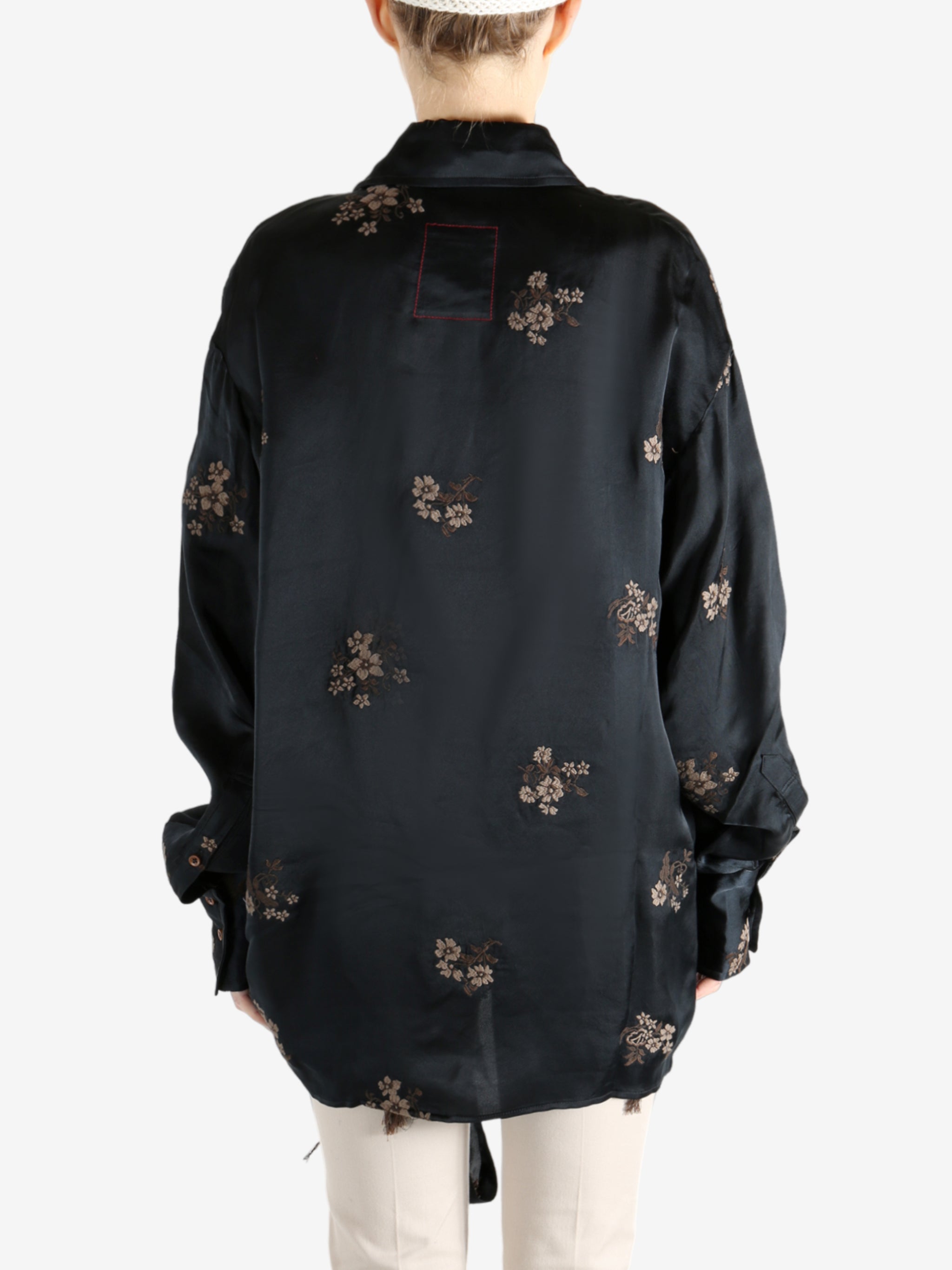 Black top worn by a person, showing the top's fit