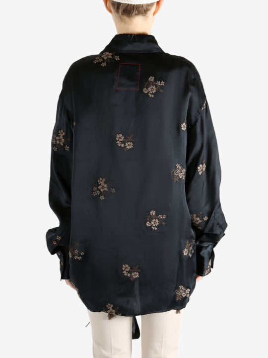 Black top worn by a person, showing the top's fit