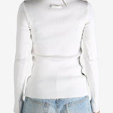 White top worn by a person, showing the top's  fit