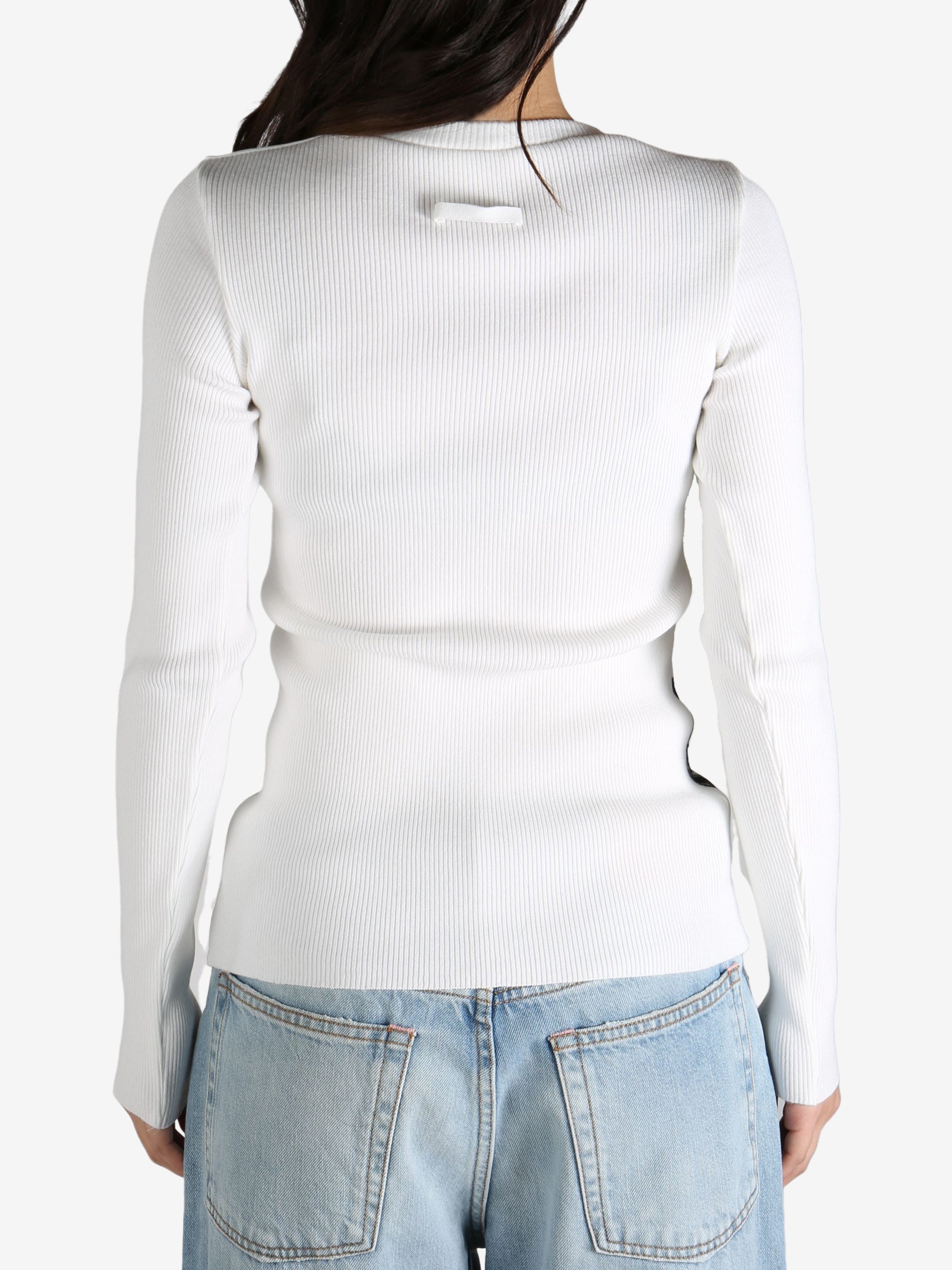 White top worn by a person, showing the top's  fit
