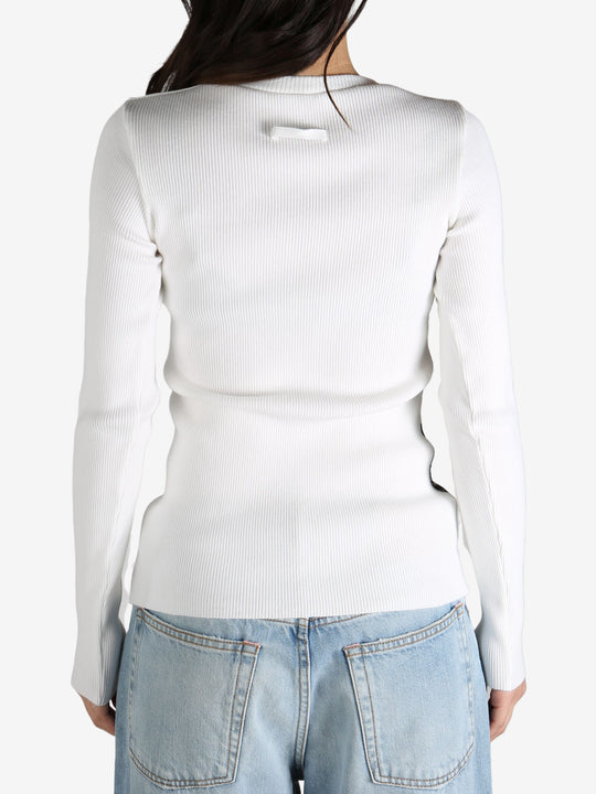 White top worn by a person, showing the top's  fit