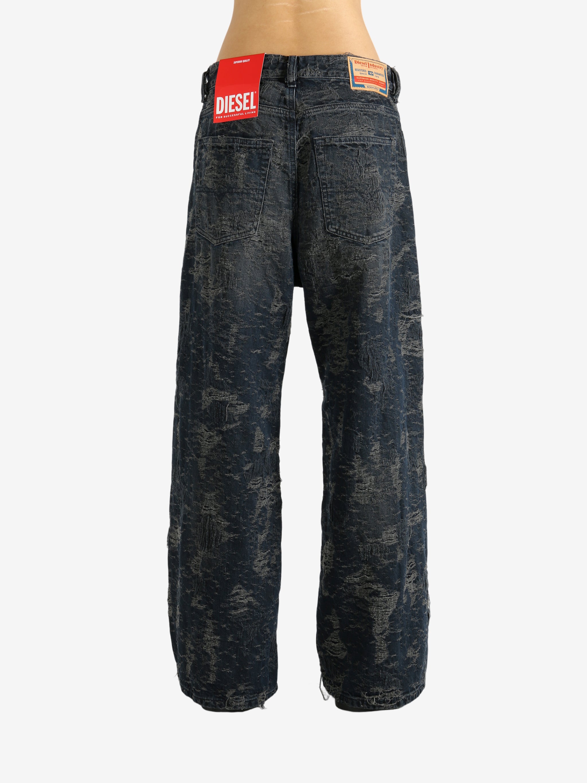 Black jeans worn by a person, showing the jeans' fit