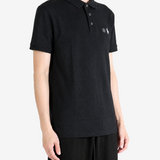 Black top worn by a person, showing the top fit