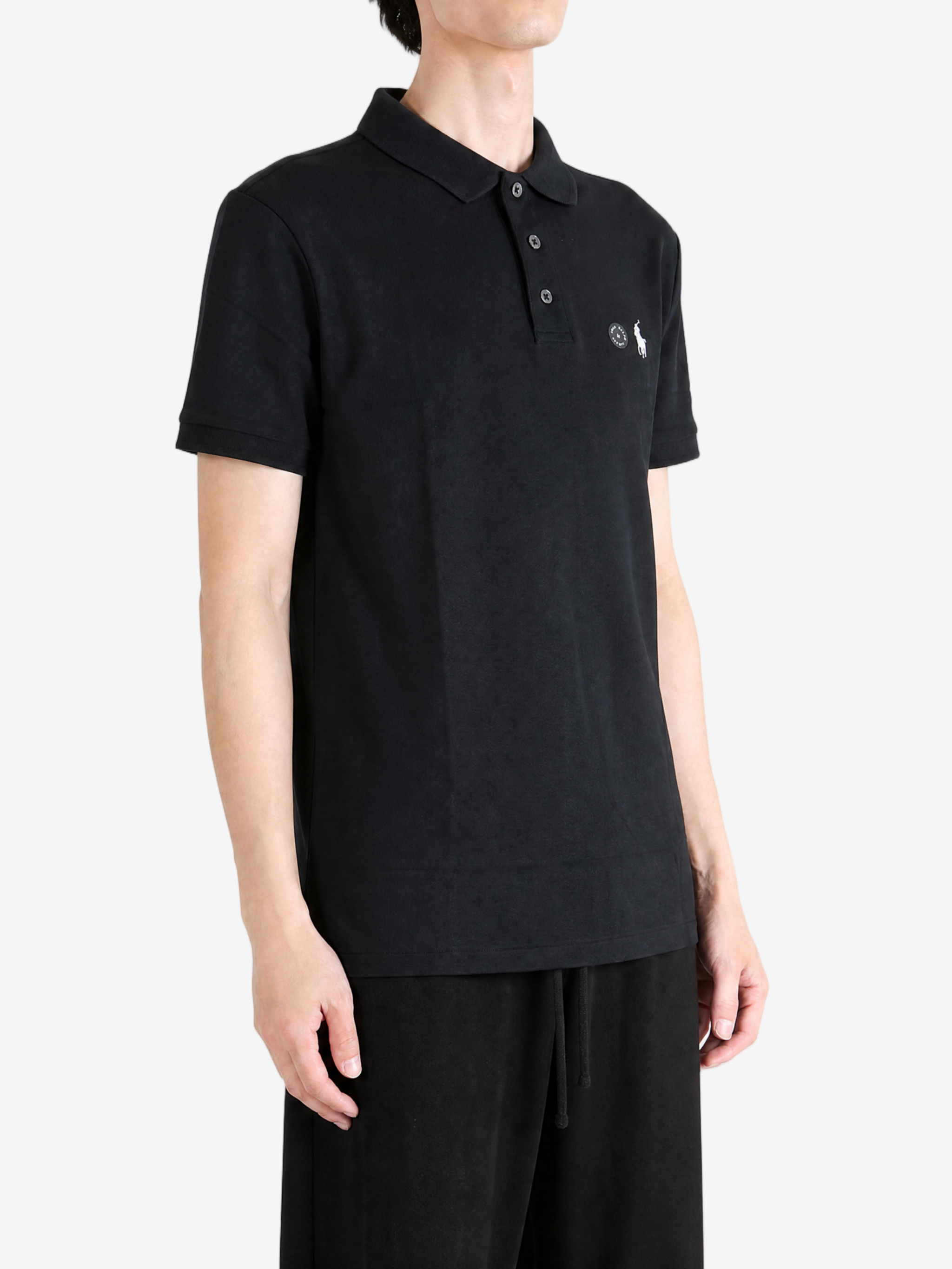 Black top worn by a person, showing the top fit
