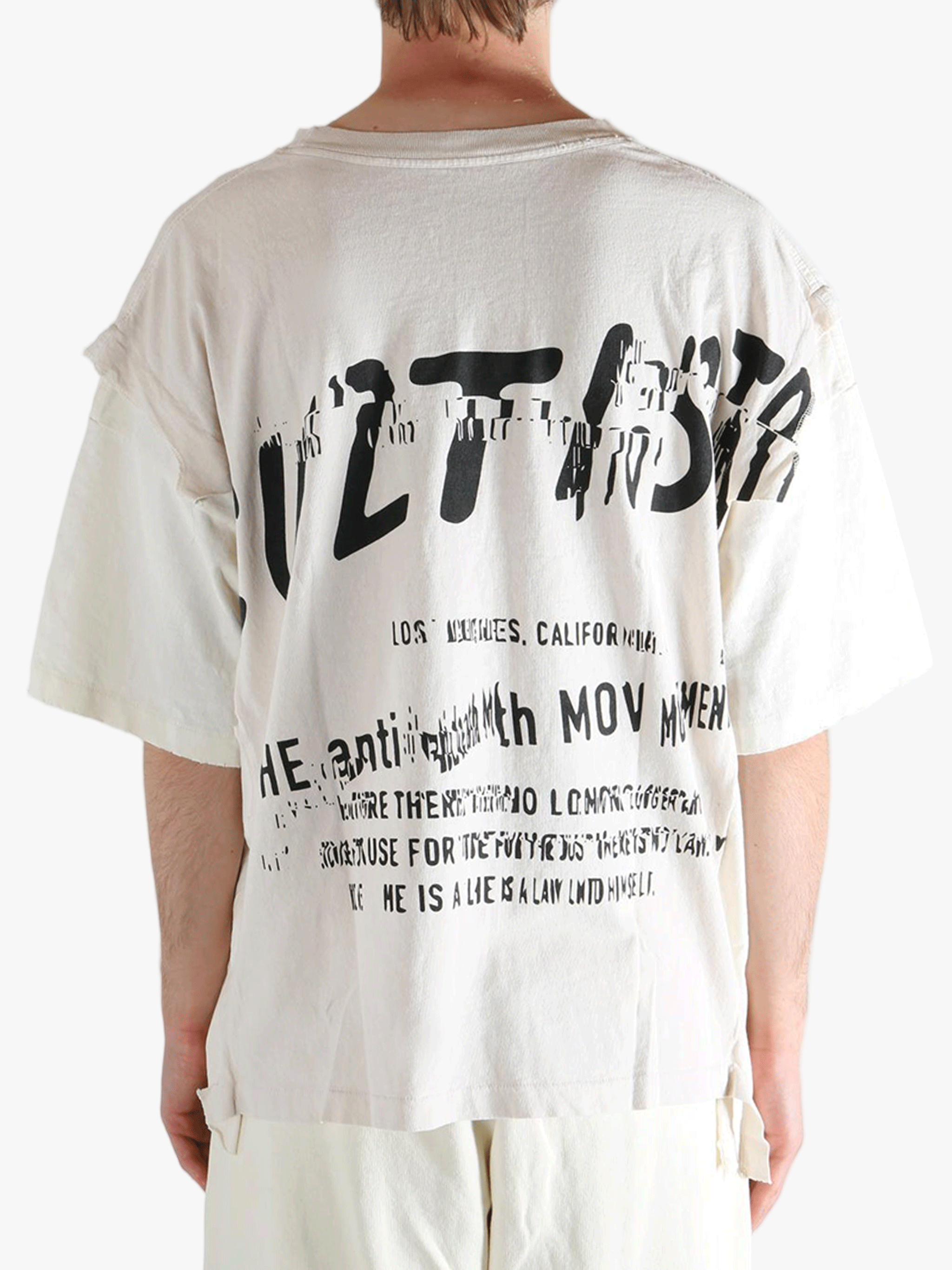 White t-shirt worn by a person, showing the t-shirt's fit