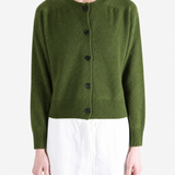 Green knitwear worn by a person, showing the knitwear fit