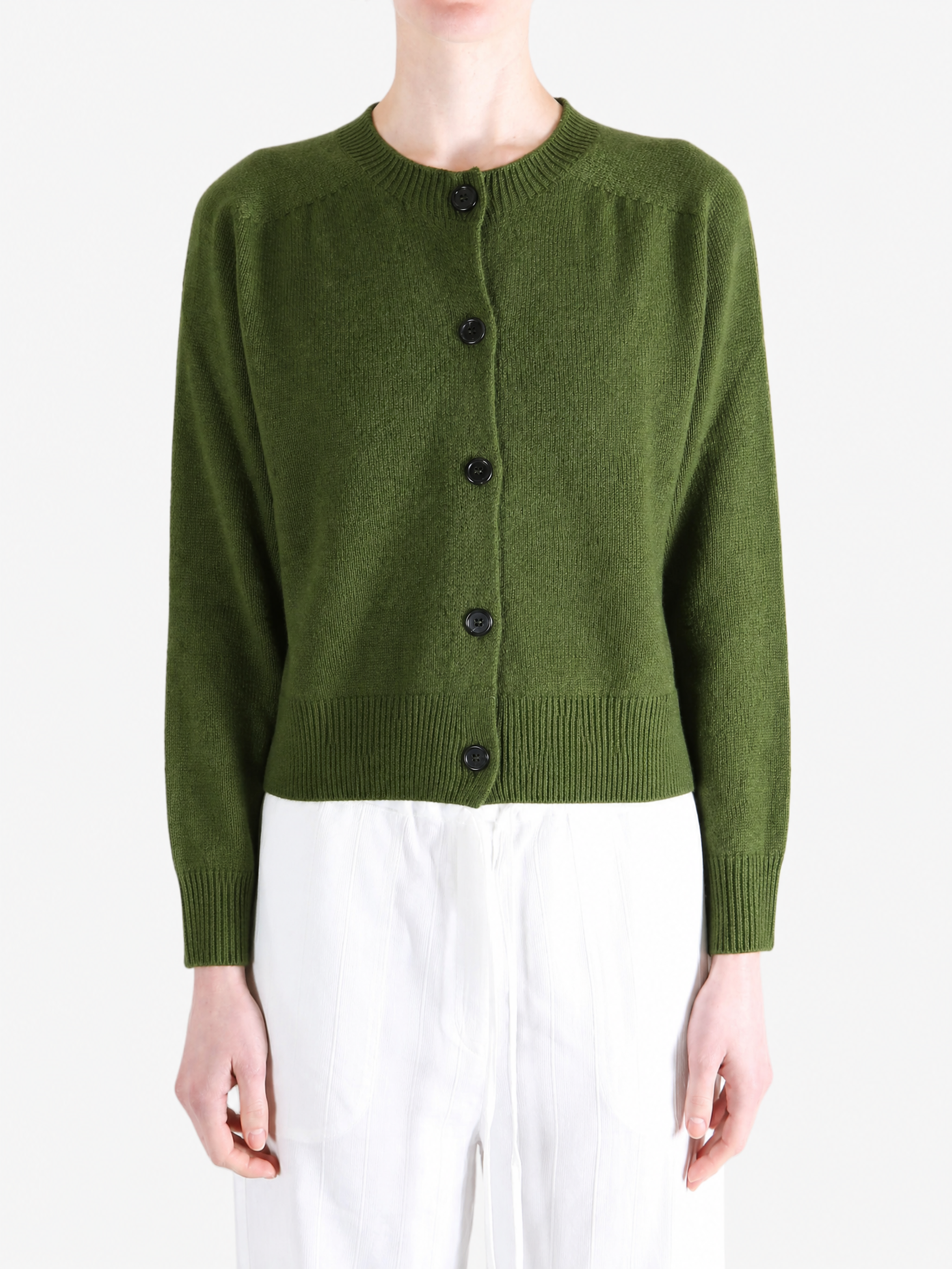 Green knitwear worn by a person, showing the knitwear fit