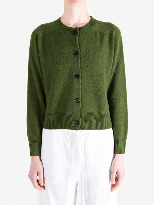 Green knitwear worn by a person, showing the knitwear fit
