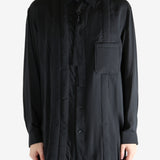 Black shirt worn by a person, showing the shirt's fit