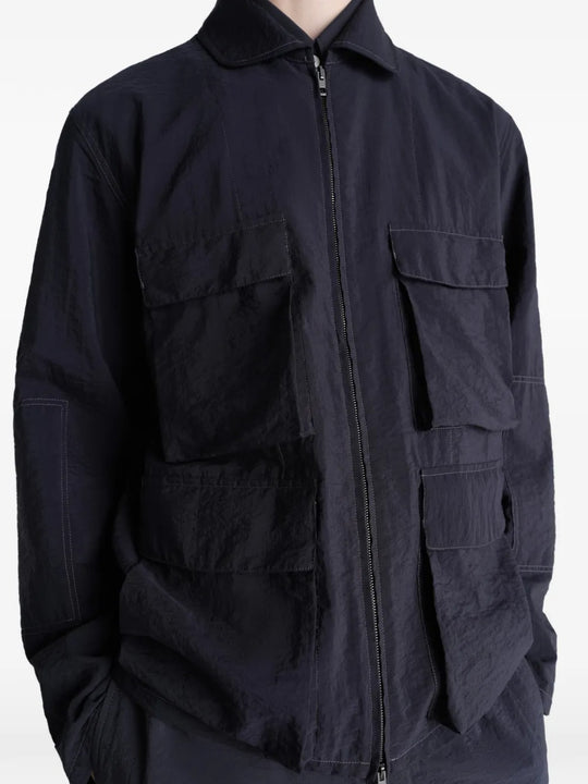 Close up of the black jacket, showing texture of the cotton fabric