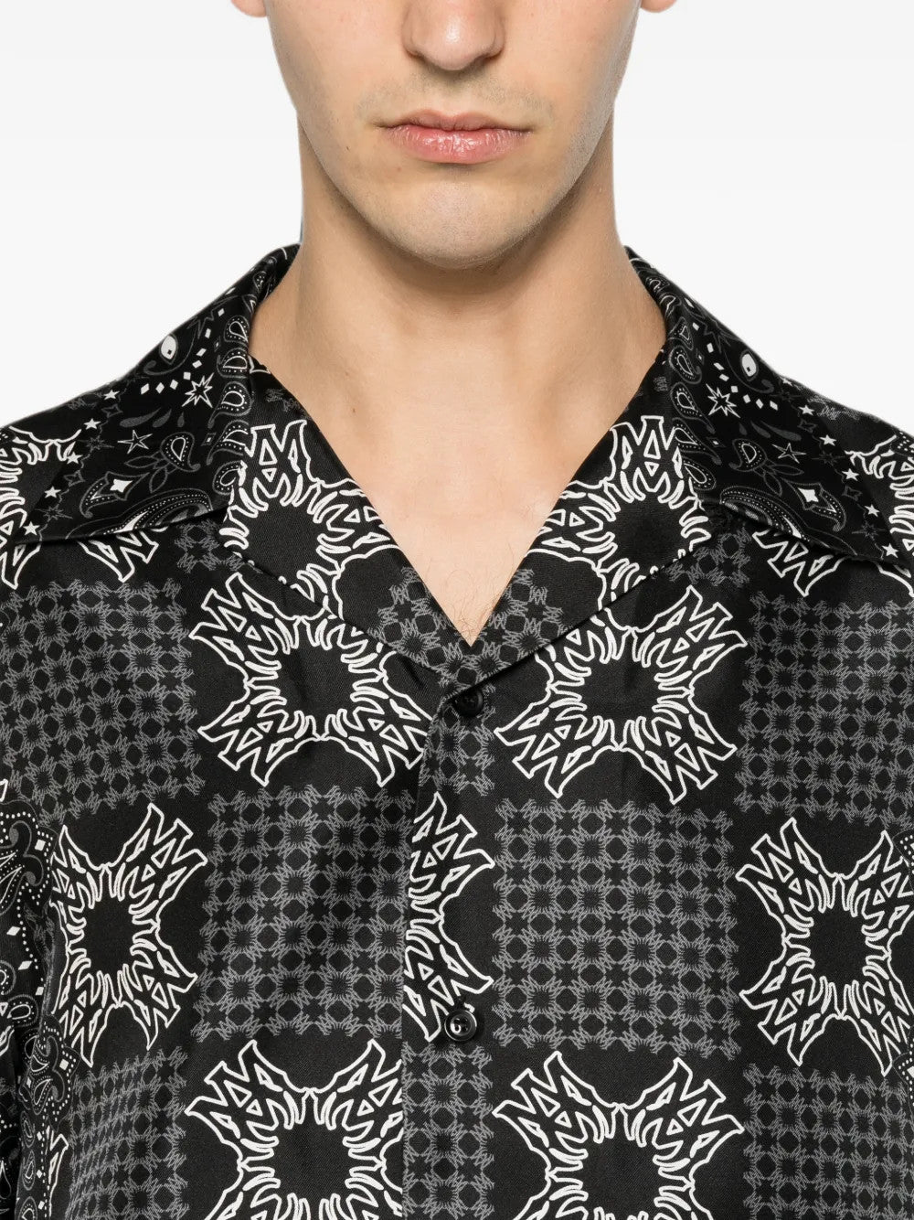 Black shirt worn by a person, showing the shirt fit