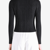 Black knitwear worn by a person, showing the knitwear fit