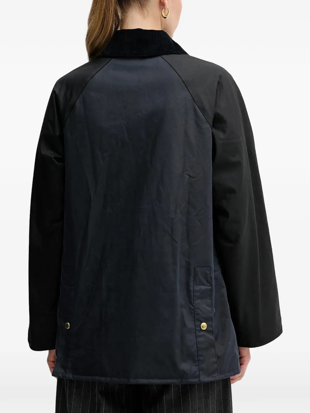 Black jacket worn by a person, showing the jacket fit