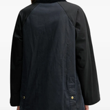 Black jacket worn by a person, showing the jacket fit