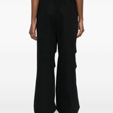 Black pants worn by a person, showing the pants 's fit