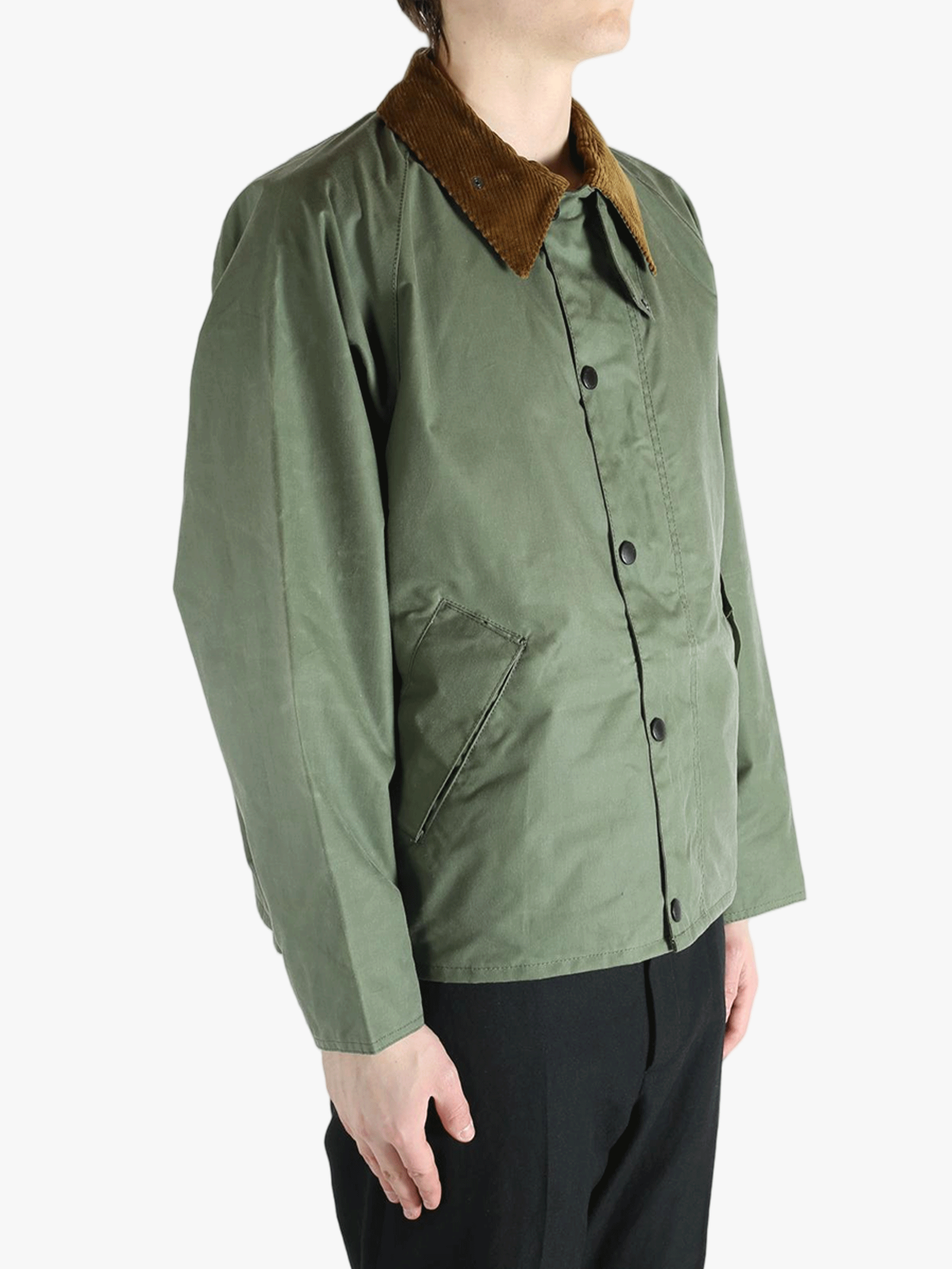 Green jacket worn by a person, showing the jacket fit