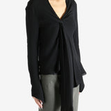 Black top worn by a person, showing the top's fit