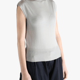 White top worn by a person, showing the top's fit