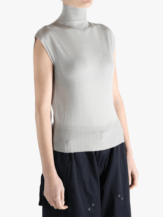 White top worn by a person, showing the top's fit