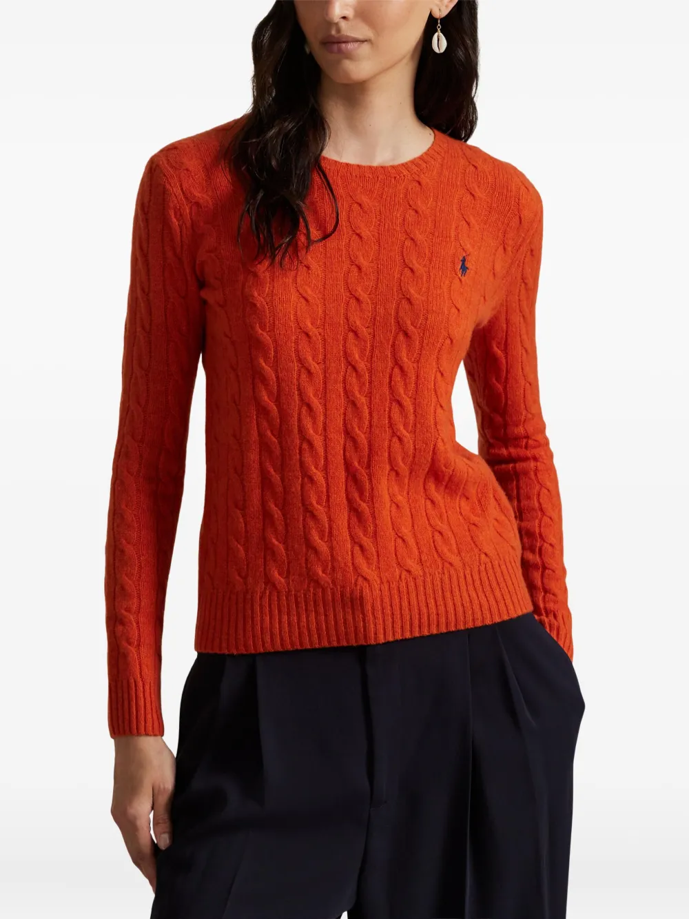 Orange knitwear worn by a person, showing the knitwear's fit
