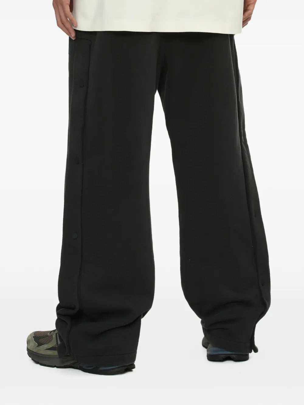 Black pants worn by a person, showing the pants' fit