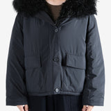 Black coat worn by a person, showing the coat's fit