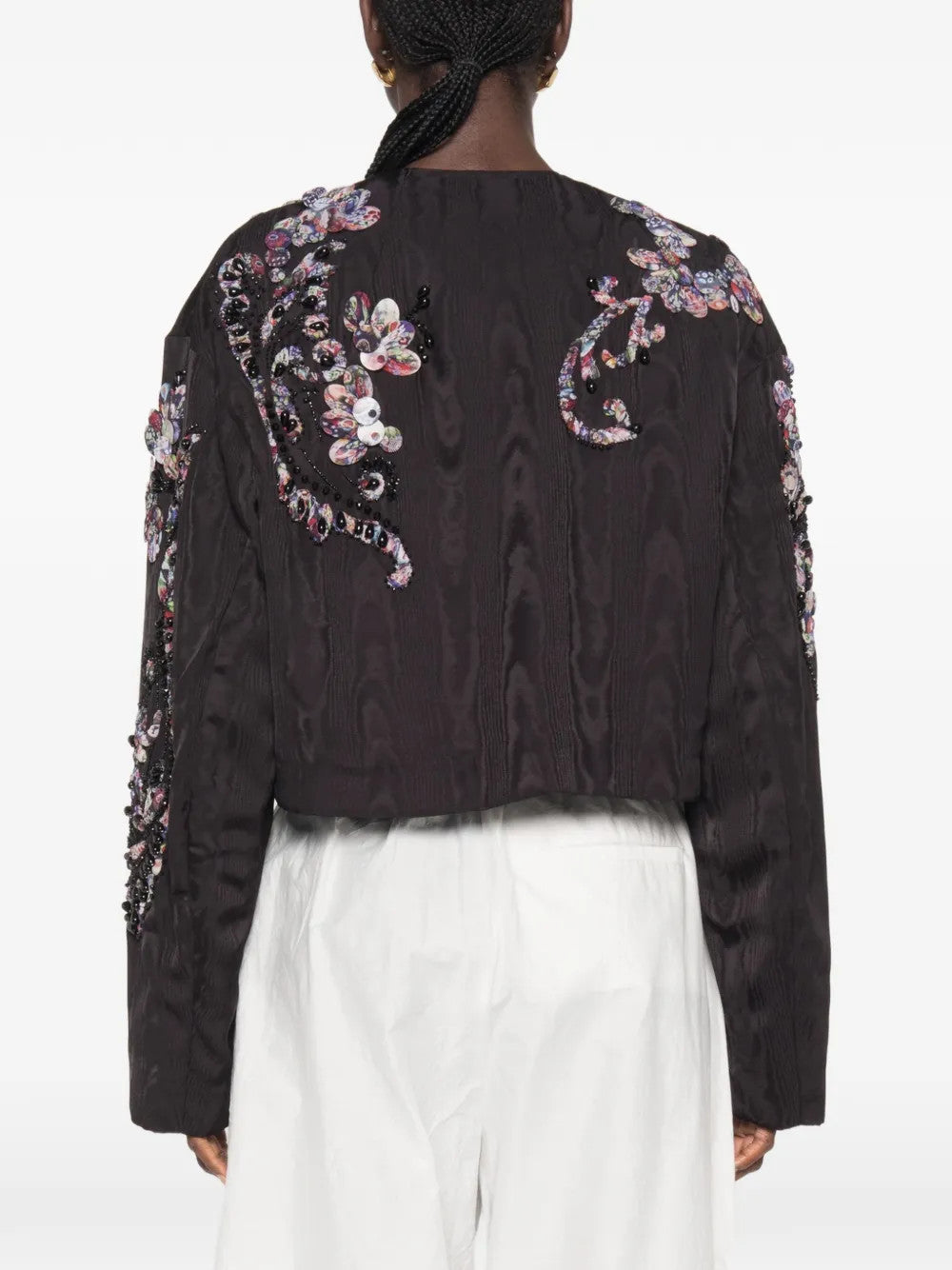 Black jacket worn by a person, showing the jacket fit