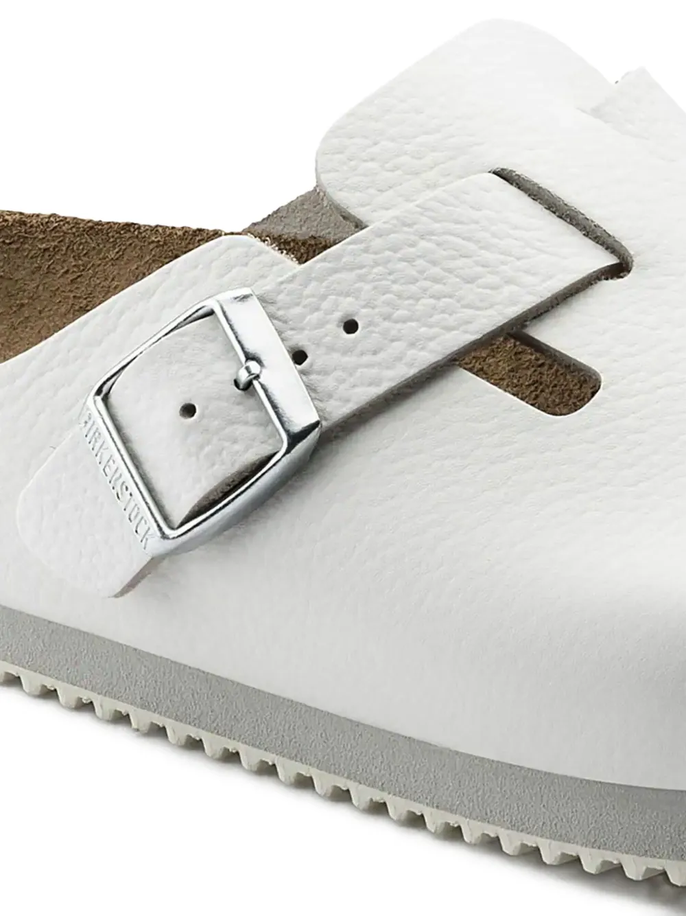Close up of white sandals, showing the detial of buckle
