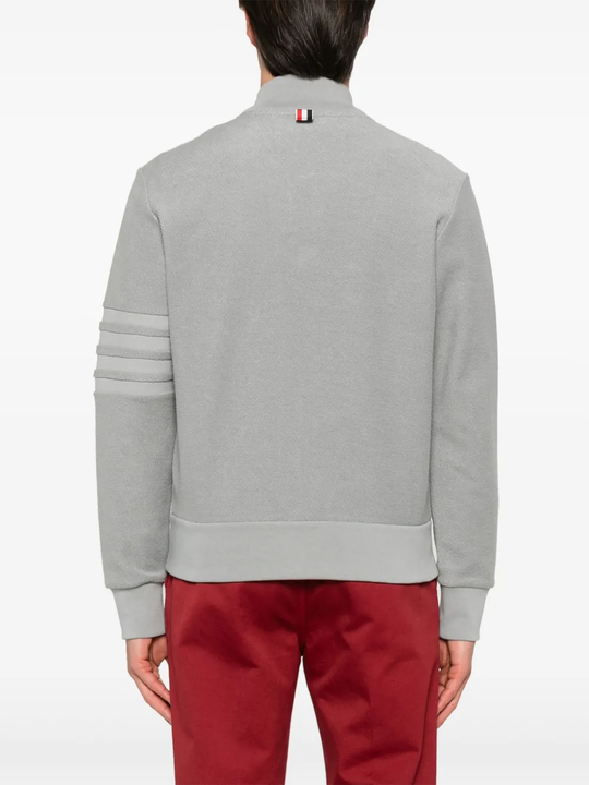 Grey jacket worn by a person, showing the jacket's fit