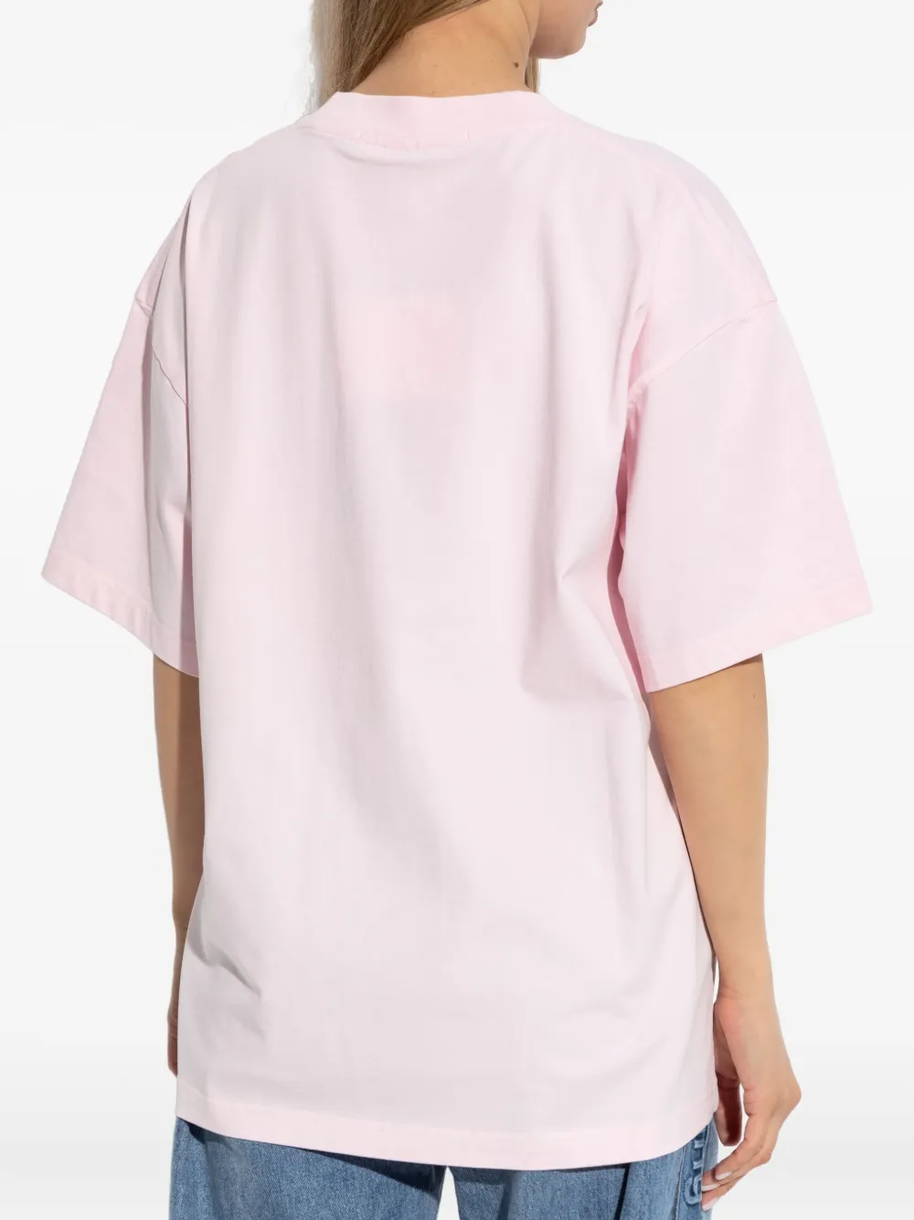 Pink t-shirt worn by a person, showing the shirt's fit