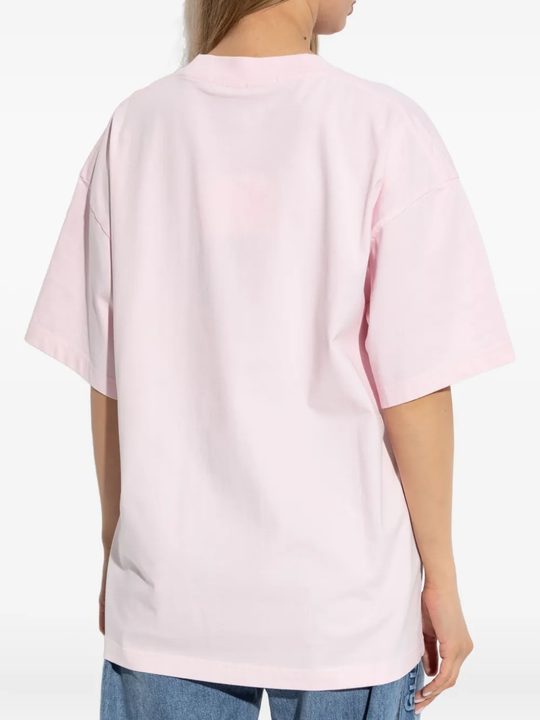 Pink t-shirt worn by a person, showing the shirt's fit
