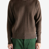 Brown knitwear worn by a person, showing the knitwear's fit