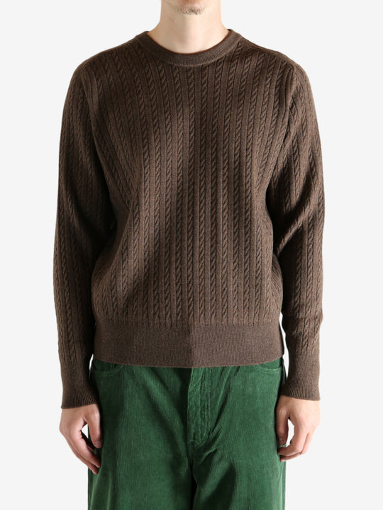 Brown knitwear worn by a person, showing the knitwear's fit