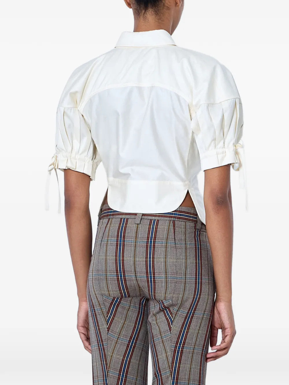 White top worn by a person, showing the top fit