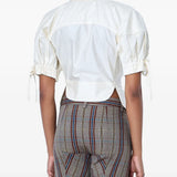 White top worn by a person, showing the top fit