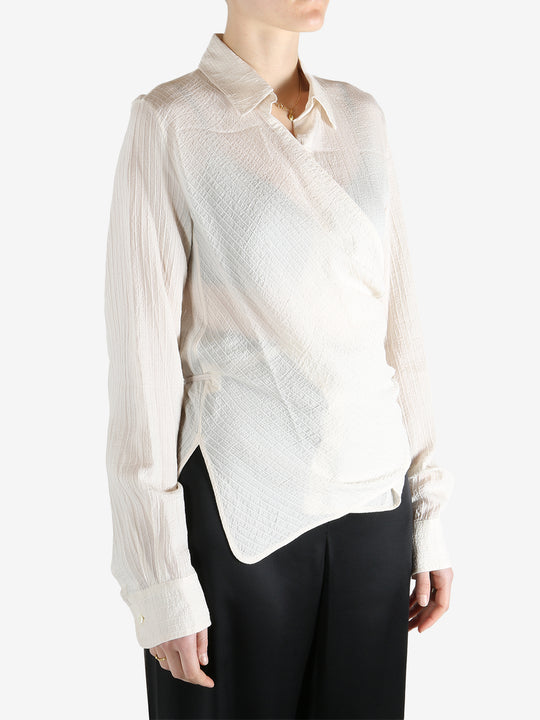 Tan shirt worn by a person, showing the shirt's fit