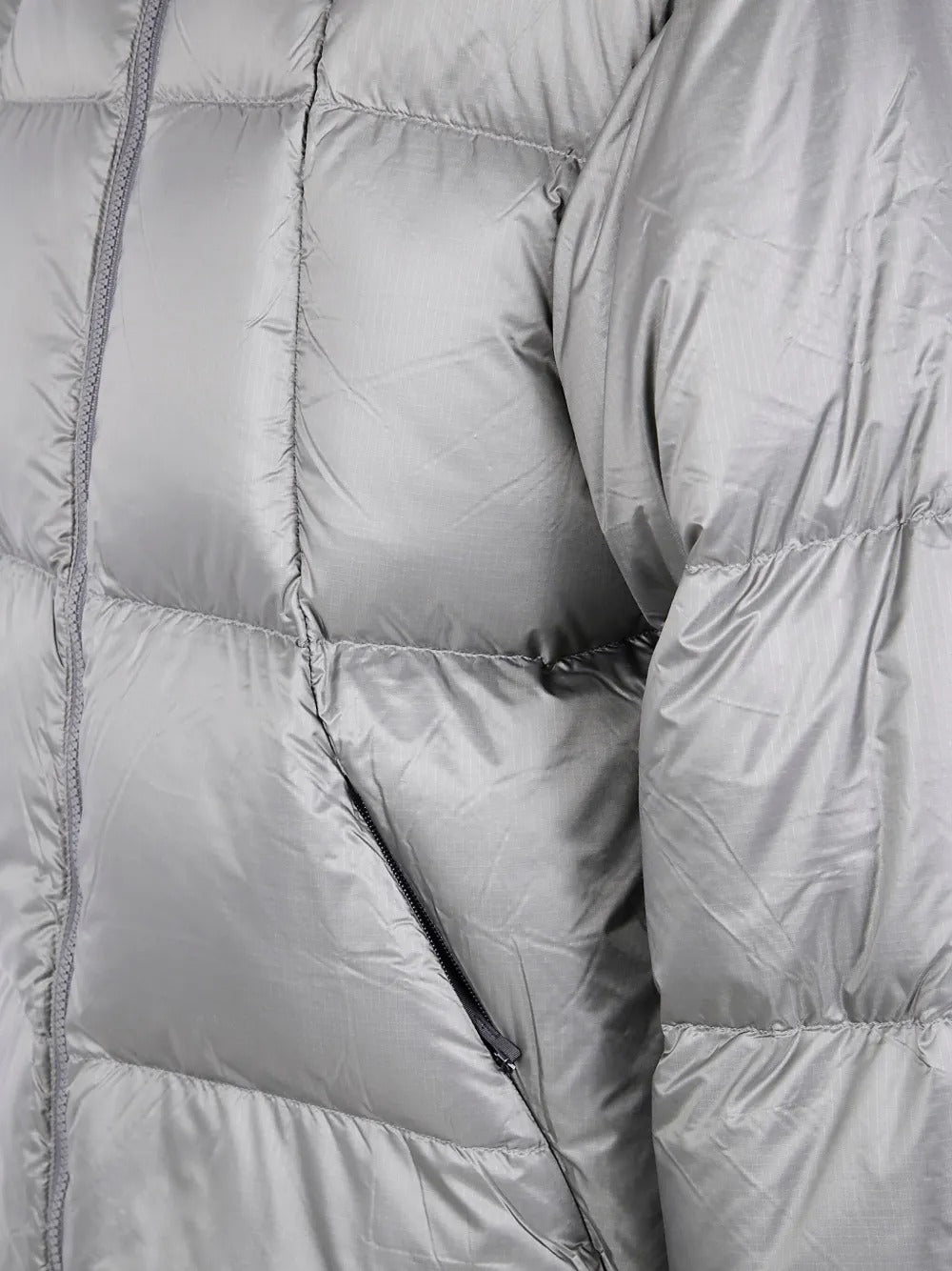 Close up of the grey parka, showing texture of the nylon fabric