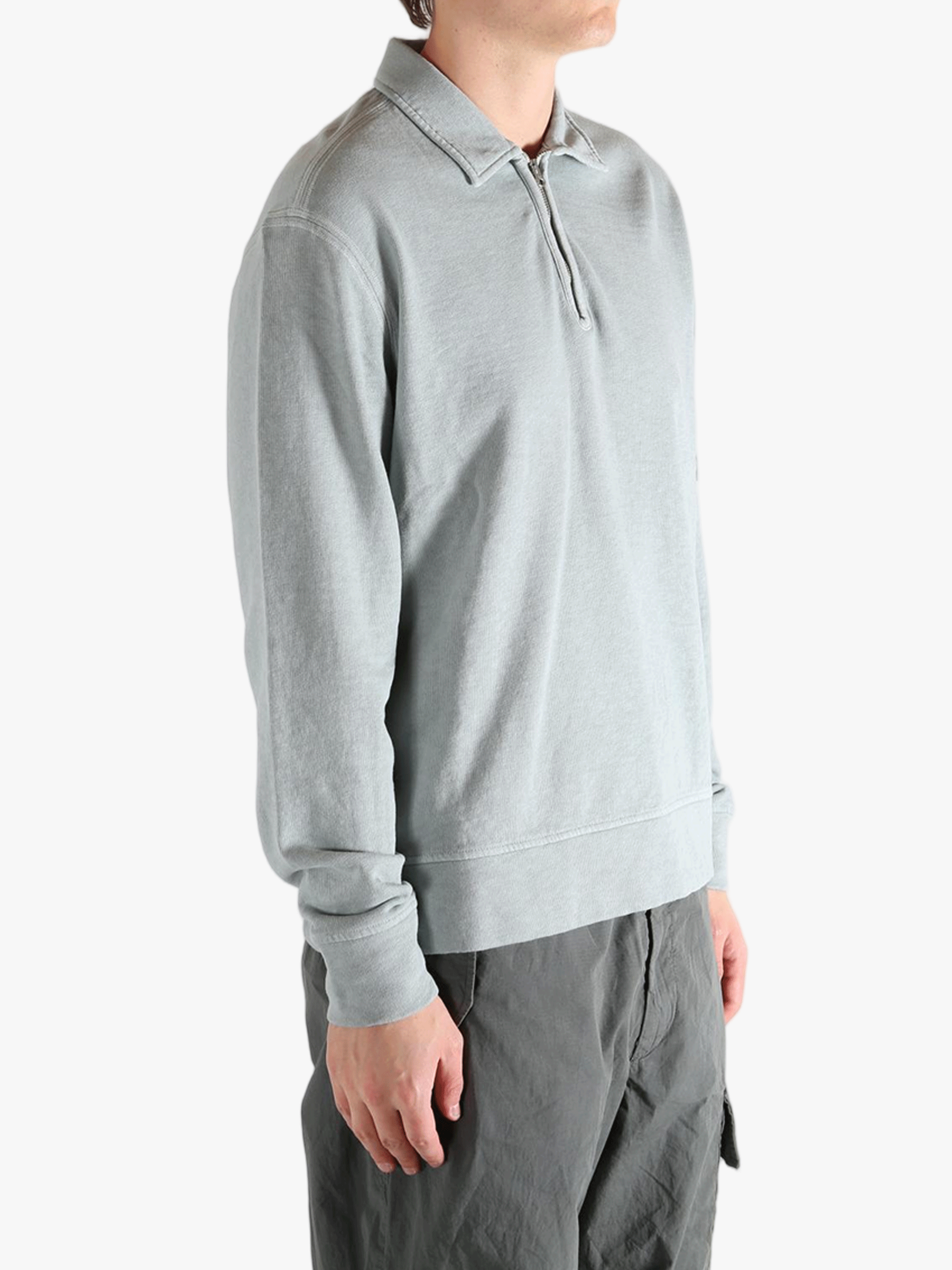 Gray long-sleeve shirt worn by a person, showing the shirt's fit