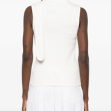 White top worn by a person, showing the top's fit