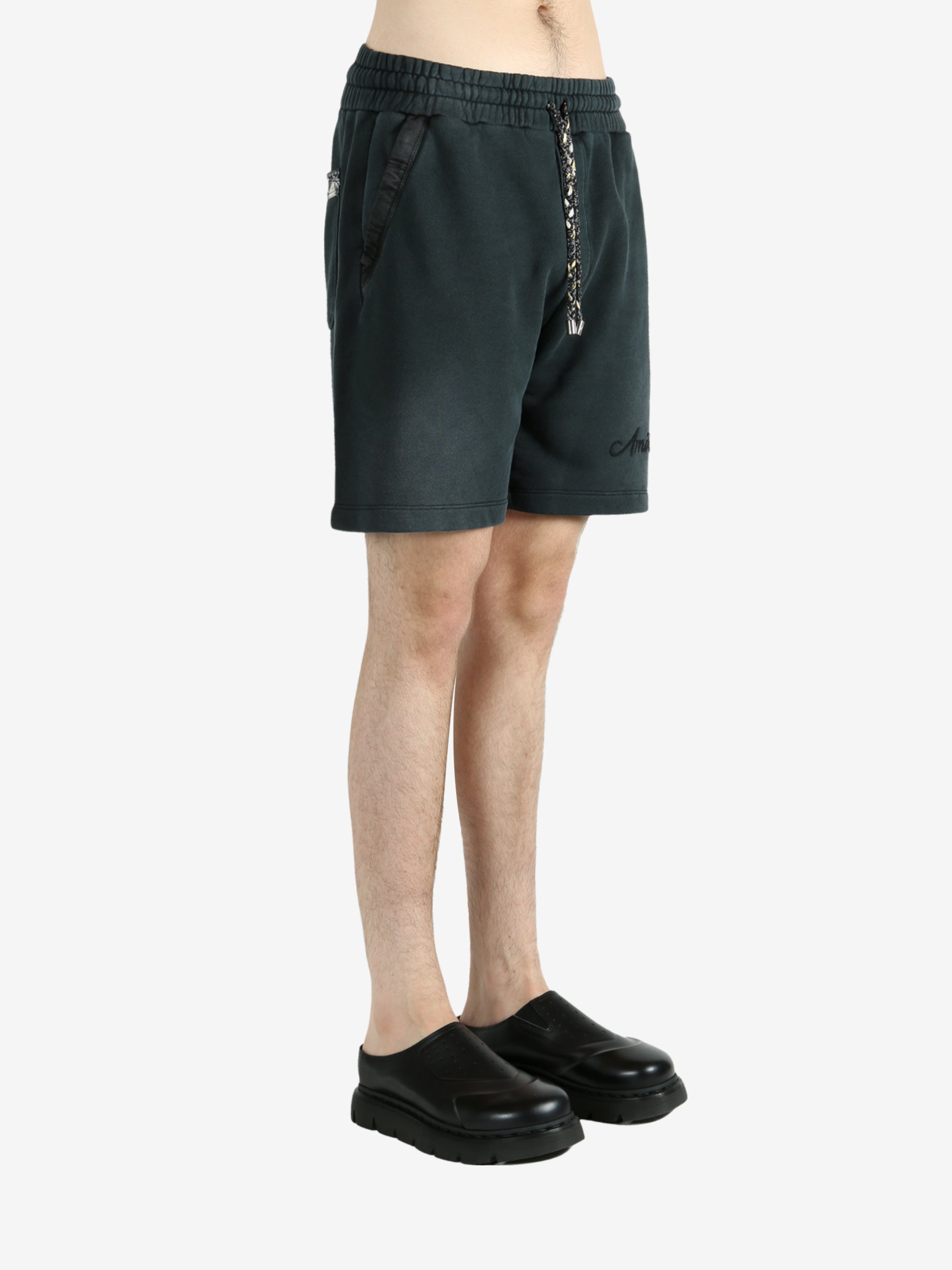 Black shorts worn by a person, showing the shorts’ fit