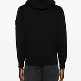 Black sweater worn by a person, showing the sweater's fit