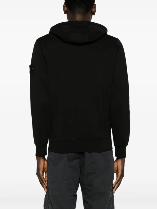Black sweater worn by a person, showing the sweater's fit