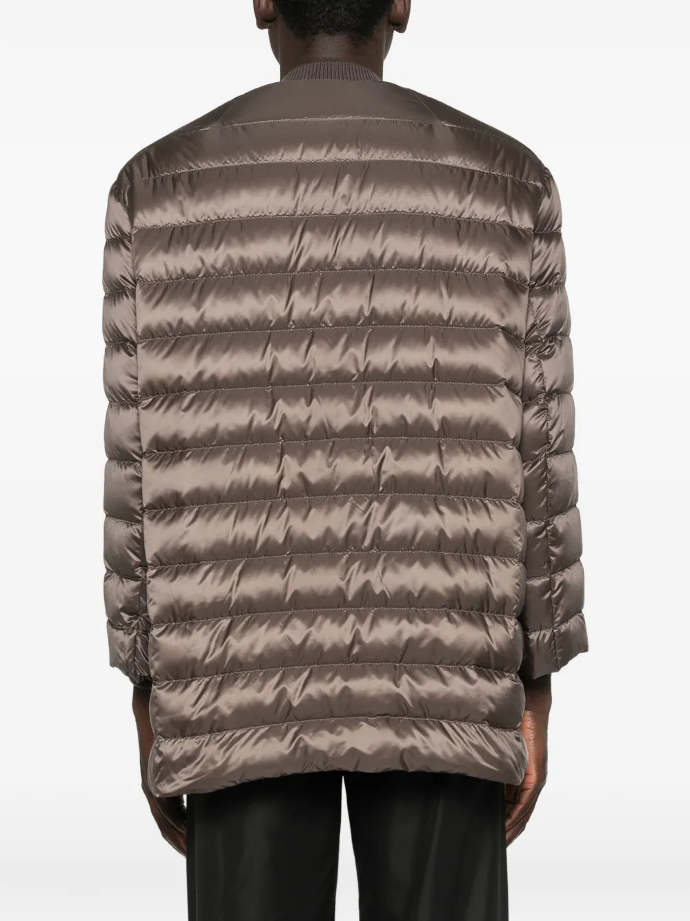 Brown parka worn by a person, showing the parka fit