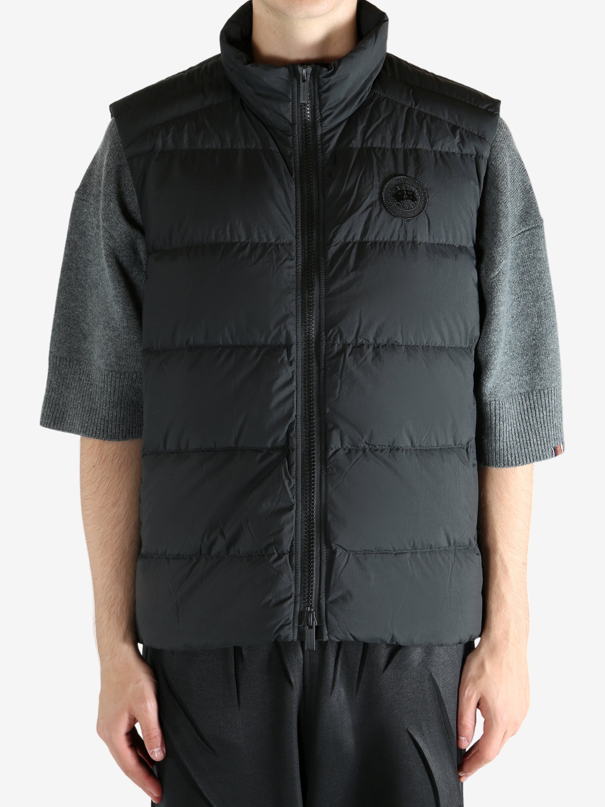 Black vest worn by a person, showing the vest's fit