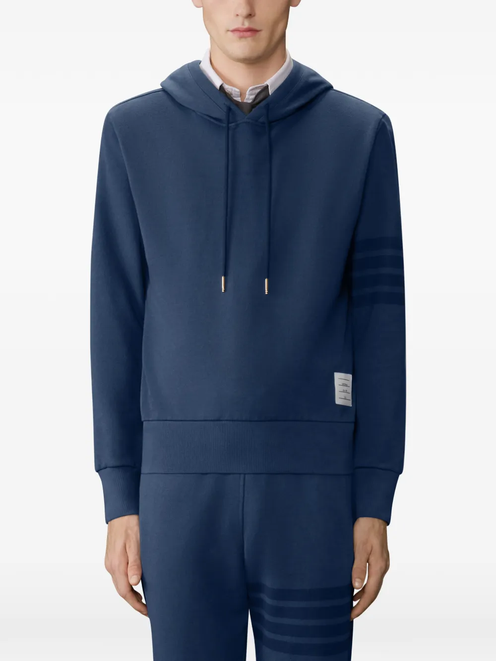 navy hoodie worn by a person, showing the hoodie fit