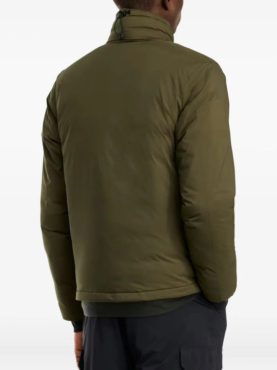 Green jacket worn by a person, showing the jacket fit
