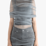 Grey shirt worn by a person, showing the tight fit.