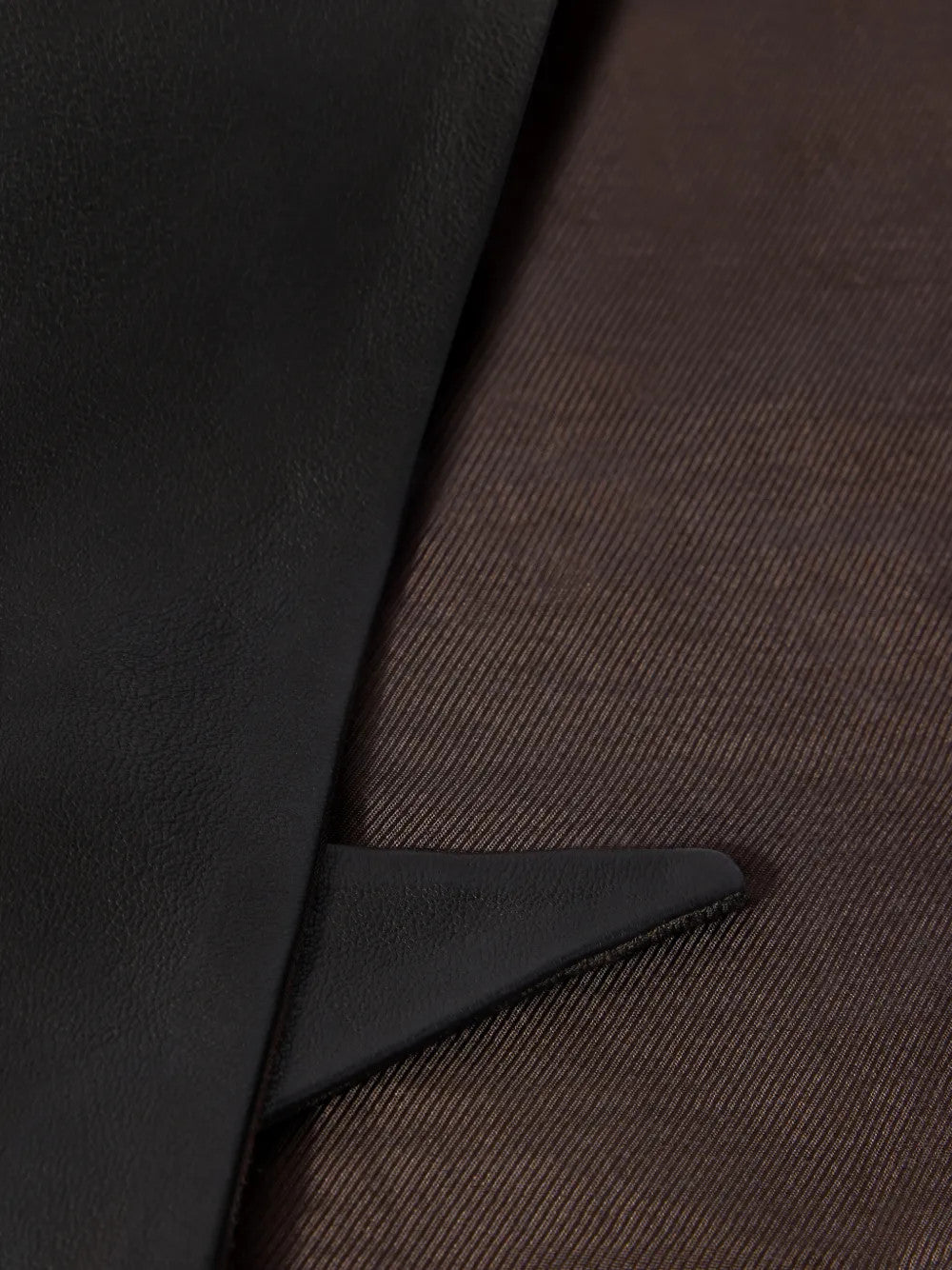 Close up of Black scarf, showing texture of the 100% calf leather made fabric