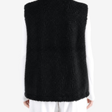 Black top worn by a person, showing the top fit